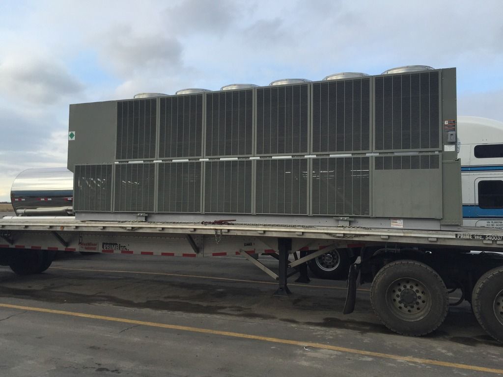 large air-conditioning unit loaded on flatbed trailer in Colorado