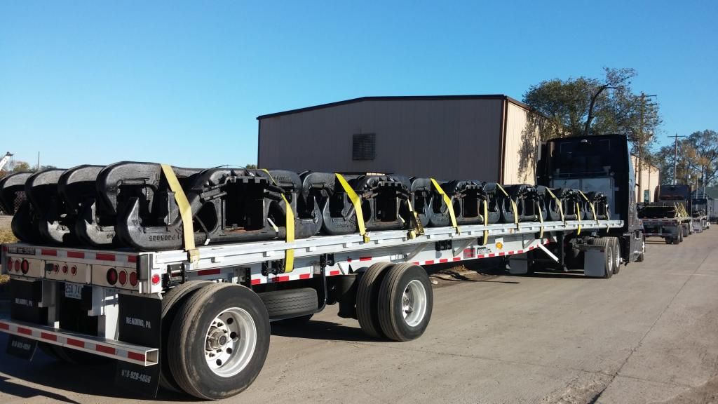 flatbed loaded with rail car suspension parts