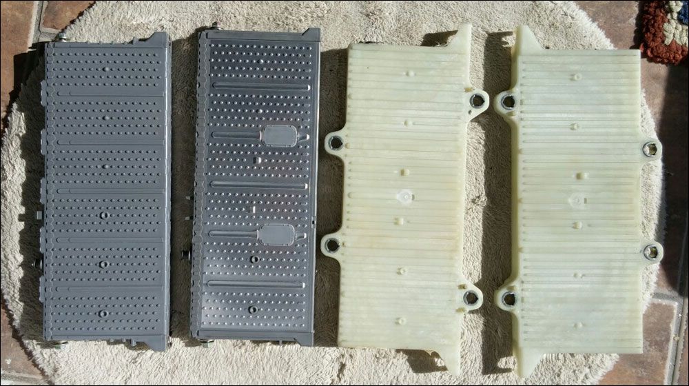 Two Prius 6 cell modules along with the module stack end plates. The all grey module is the type used in 2001-3 model years and the one with the shiny metal skin is from the 2004-15 model years.
